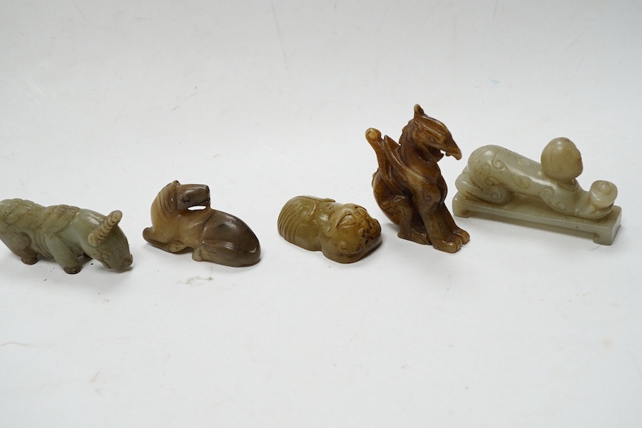 Four Chinese jade carvings, of a horse, cicada, a winged beast, a kneeling man, and a horned beast, longest 7cm. Condition - good